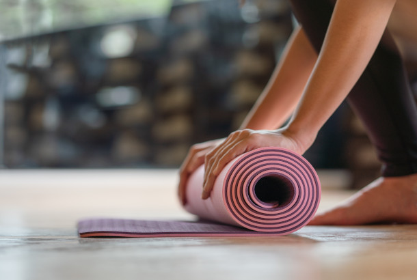 Women rolling Pilates mat