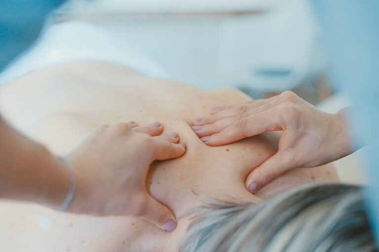 Osteopaths hands on a patients back