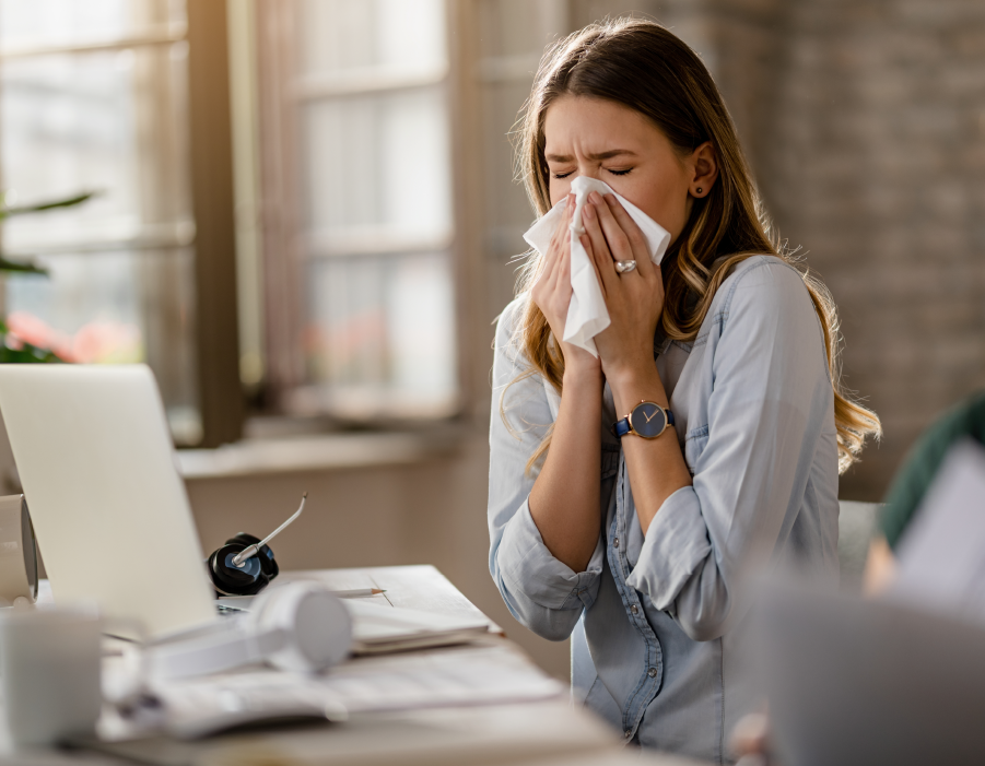 Woman with hayfever sneezing