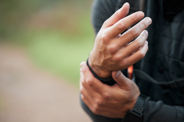 Person holding their wrist